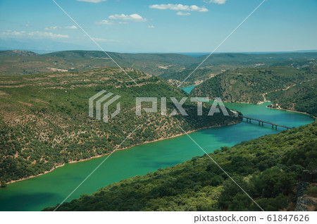 Tagus River and bridge in a valley with hills at the Monfrague National Park 61847626