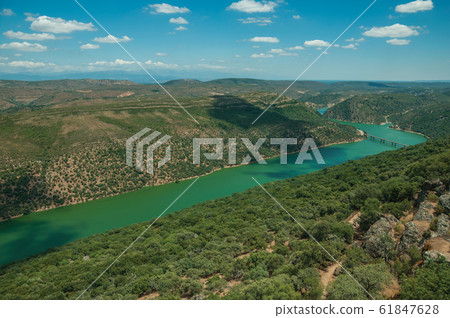 Tagus River and bridge in a valley with hills at the Monfrague National Park Tagus River and bridge in a valley with hills at the Monfrague National Park 61847628