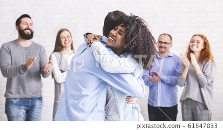Diverse people hugging after successful workshop or seminar 61847833