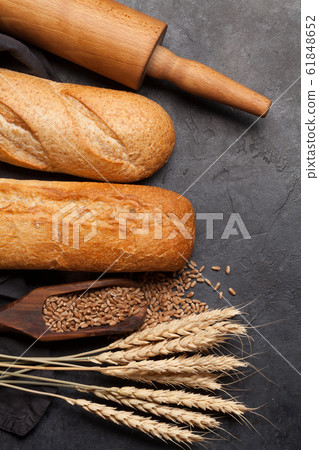Various bread with wheat and cooking utensils Various bread with wheat and cooking utensils 61848652