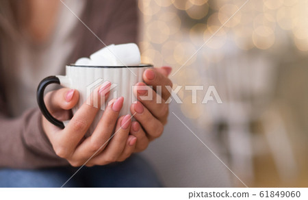 Cup of hot chocolate with marshmallows in female hands Cup of hot chocolate with marshmallows in female hands 61849060