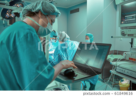 Surgeons team in the operating room, portraits close-up. modern operating, plastic surgery. Beauty industry 61849616