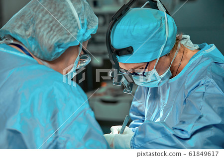 Surgeons team in the operating room, portraits close-up. modern operating, plastic surgery. Beauty industry 61849617