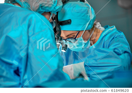 Surgeons team in the operating room, portraits close-up. modern operating, plastic surgery. Beauty industry 61849620