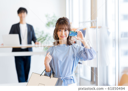 Young woman with shopping and credit card Young woman with shopping and credit card 61850494