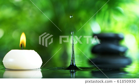 Dripping drops of water with black lava stones 61850930