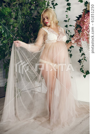 Beautiful pregnant woman with big belly in a studio Beautiful pregnant woman with big belly in a studio 61851250