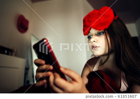 Girl using mobile phone for making portrait and sending virtual message Girl using mobile phone for making portrait and sending virtual message 61851607