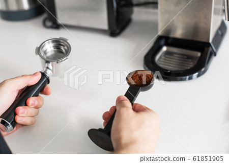 Guy prepare delicious aromatic coffee in a coffee Guy prepare delicious aromatic coffee in a coffee 61851905