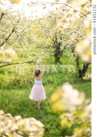 Young attractive girl walks in spring green park Young attractive girl walks in spring green park 61852132