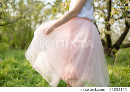 Young attractive girl walks in spring green park 61852133