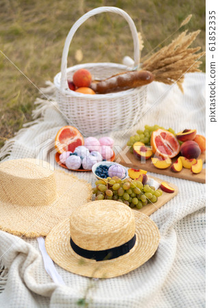 Stylish summer picnic on a white blanket. Stylish summer picnic on a white blanket. 61852335