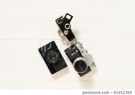 Vintage cameras on the white wooden background. Concept of old technology. Photo with place for text. Sweden. Scandinavia. Top view Vintage cameras on the white wooden background. Concept of old technology. Photo with place for text. Sweden. Scandinavia. Top view 61852369