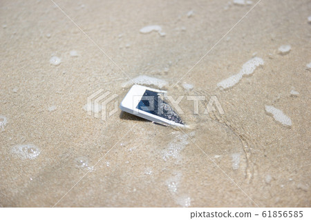 White Mobile phone floated to the sea at the beach. White Mobile phone floated to the sea at the beach. 61856585