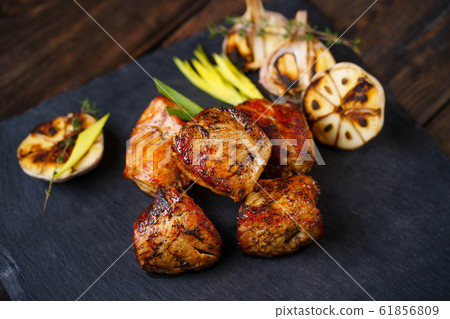 Grilled pork meat served on slate Grilled pork meat served on slate 61856809