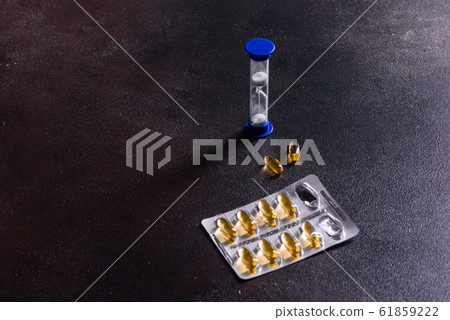 Omega 3 capsules on black dark background Omega 3 capsules on black dark background 61859222