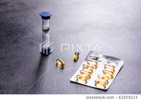 Omega 3 capsules on black dark background Omega 3 capsules on black dark background 61859223