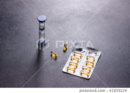 Omega 3 capsules on black dark background Omega 3 capsules on black dark background 61859224