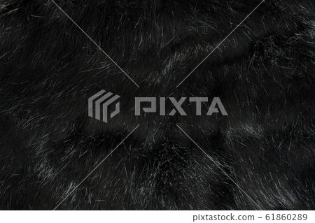 Background texture of black fur made of synthetic animal long hair. Background texture of black fur made of synthetic animal long hair. 61860289