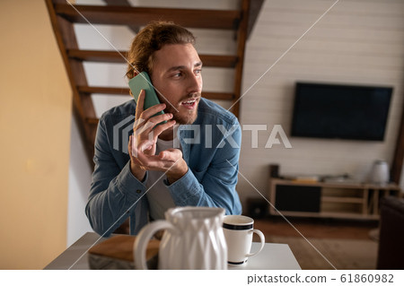 Handsome man talking on phone with his girlfriend 61860982