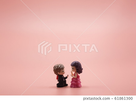 A young man's lover doll is surprise romantic his girlfriend with a red rose.14 fourteen feb or february Valentine day for To propose to you just marries wedding on pink gold background romance A young man's lover doll is surprise romantic his girlfriend with a red rose.14 fourteen feb or february Valentine day for To propose to you just marries wedding on pink gold background romance 61861300