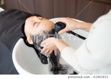 Senior woman doing hair care in a beauty salon Senior woman doing hair care in a beauty salon 61863631