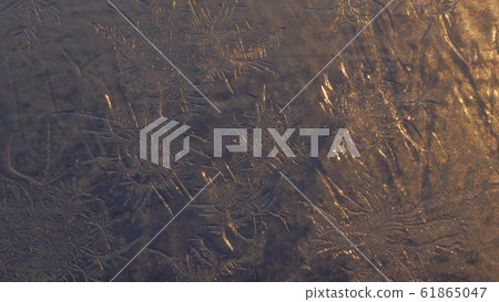 Snowflakes on the window in supermacro shooting. Snowflakes on the window in supermacro shooting. 61865047