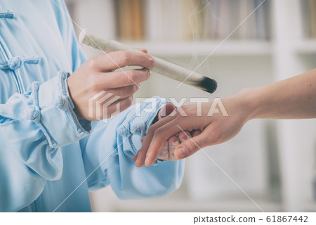 Therapist doing moxa treatment Therapist doing moxa treatment 61867442