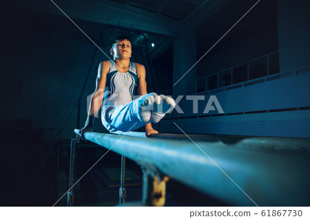 Little male gymnast training in gym, flexible and active 61867730
