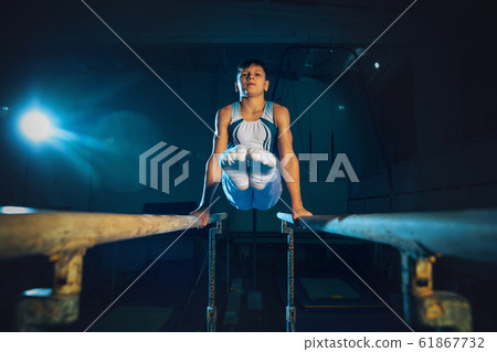 Little male gymnast training in gym, flexible and active 61867732