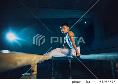 Little male gymnast training in gym, flexible and active Little male gymnast training in gym, flexible and active 61867757