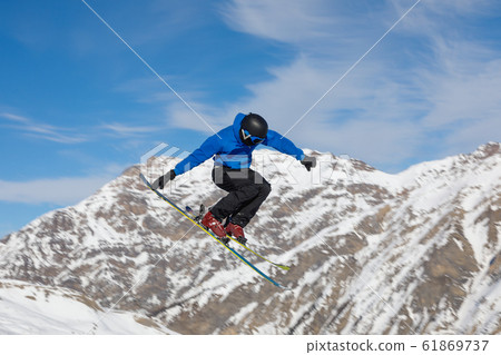 Skier does the jumping trick Skier does the jumping trick 61869737