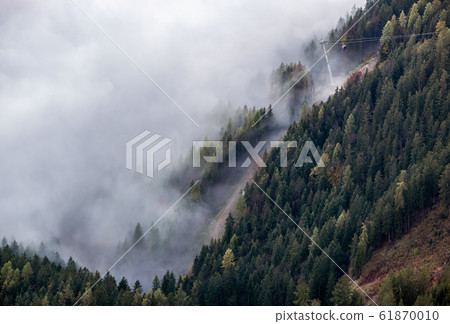 Cable car gondolas moving across the Alps mountain Cable car gondolas moving across the Alps mountain 61870010