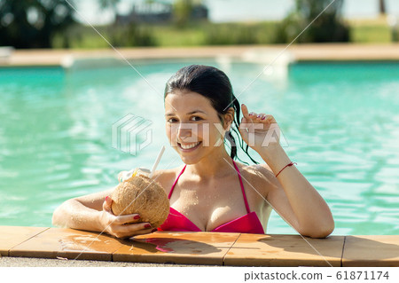 Sexy slim girl enjoys relaxing near the pool, with Sexy slim girl enjoys relaxing near the pool, with 61871174