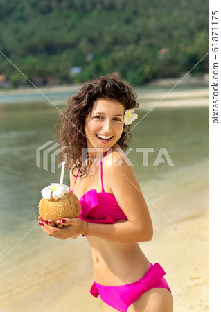 Sexy slim girl enjoys relaxing on the shore of a Sexy slim girl enjoys relaxing on the shore of a 61871175