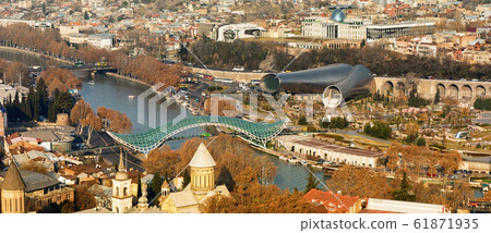 Beautiful view of Kura river and Bridge of Peace in Tbilisi. Bridge is a bow-shaped pedestrian bridge in Tbilisi Beautiful view of Kura river and Bridge of Peace in Tbilisi. Bridge is a bow-shaped pedestrian bridge in Tbilisi 61871935