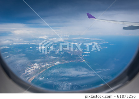 Wing of airplane flying above Hong Kong city Wing of airplane flying above Hong Kong city 61873256