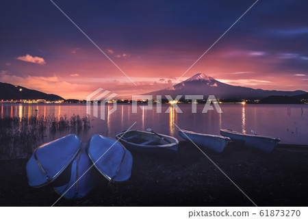 Mt. Fuji over Lake Kawaguchiko with boats at 61873270