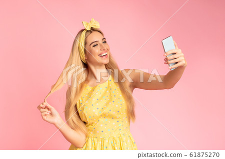 Smiling teenage girl making selfie at studio Smiling teenage girl making selfie at studio 61875270