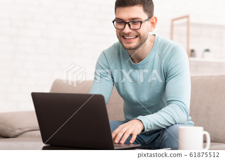 Freelancer Using Laptop Working Online Sitting On Sofa At Home Freelancer Using Laptop Working Online Sitting On Sofa At Home 61875512