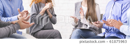 Diverse unrecognizable people applauding to woman at group therapy session 61875963
