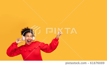 Portrait of excited black girl enjoying music Portrait of excited black girl enjoying music 61876089
