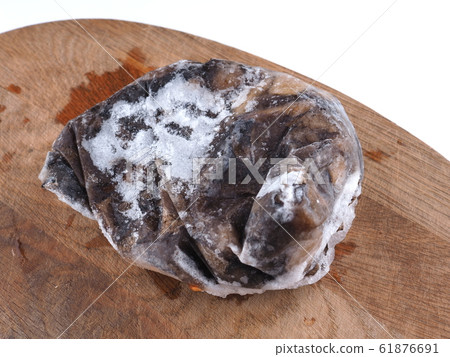 frozen mushrooms on a wooden board 61876691