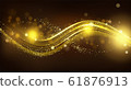 Gold sparkle wave on black blurred background. 61876913
