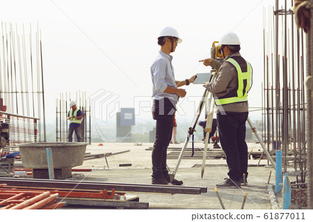 Engineers and staff are inspecting the buildings Engineers and staff are inspecting the buildings 61877011