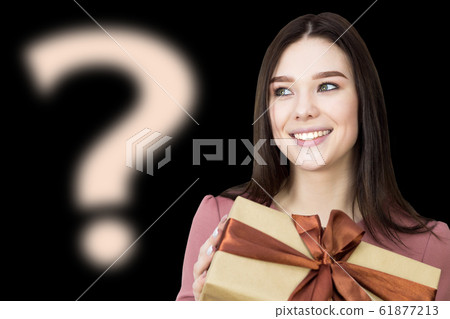 The girl is thinking about her gift, what's there. 61877213