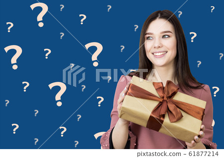 The girl is thinking about her gift, what's there. The girl is thinking about her gift, what's there. 61877214