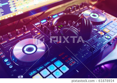 Dj mixes the track in the nightclub at a party Dj mixes the track in the nightclub at a party 61878914