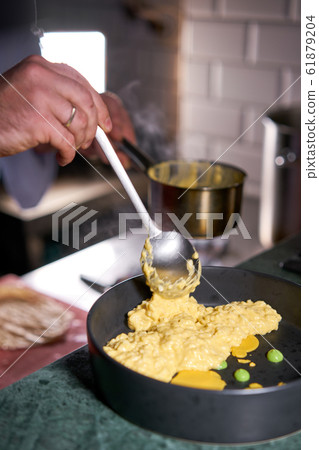 The chef serves the dish Pumpkin Risotto with with duck and parmesan cheese mousse. Seasonal autumnal recipe - risotto with organic pumpkins. 61879204
