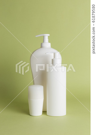 White plastic soap dispensers and deodorant. Copy space. Place for text. White plastic soap dispensers and deodorant. Copy space. Place for text. 61879580